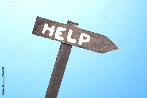 Photo: Help wooden board on blue background Help wooden board on blue background