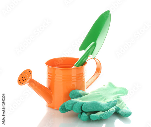 Photo: Gardening trowel, watering can and gloves isolated on white Gardening trowel, watering can and gloves isolated on white