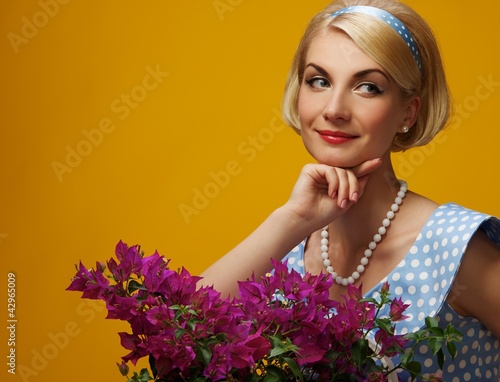 Photo: Lovely woman in a blue dress with a flowers Lovely woman in a blue dress with a flowers
