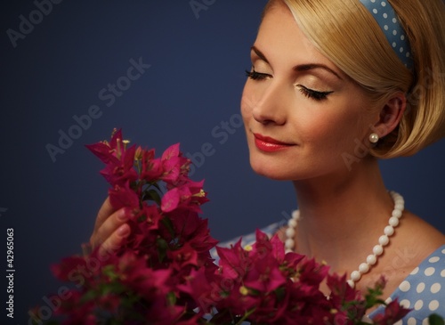 Photo: Lovely woman in a blue dress with a flowers Lovely woman in a blue dress with a flowers