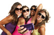 Four girls  taking pictures of themselves through cell phone