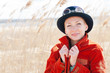 Happy woman wearing hat front of the reed