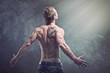 Young man with tatoo in the smoke. Magic