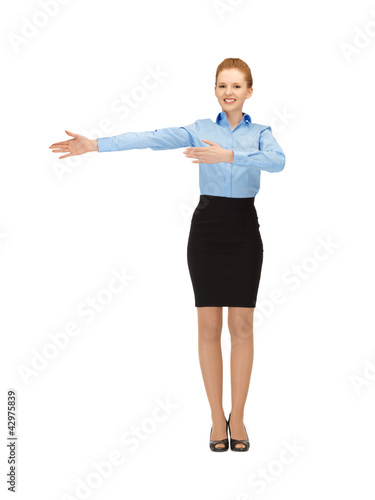 Photo: smiling stewardess showing direction smiling stewardess showing direction