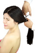woman with eyes closed scared while hairdresser cuts her hair