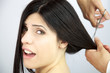 Beautiful woman screaming while her long hair are cut