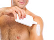 Photo: Closeup on man applying sun block creme on arm Closeup on man applying sun block creme on arm