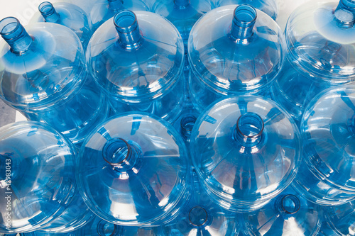 Photo: big empty water bottles at warehouse big empty water bottles at warehouse