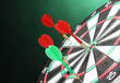 dart board with darts on green background
