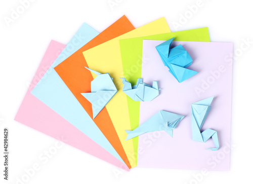 Photo: blue origami on bright paper, isolated on white blue origami on bright paper, isolated on white