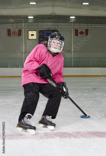 Photo: Ringette Skater in Action at Rink Ringette Skater in Action at Rink