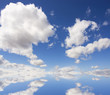 Blue sky with clouds, reflection over water