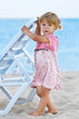 Foto: little girl on the shore of the sea little girl on the shore of the sea