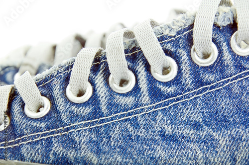 Photo: old jean canvas shoes on the background old jean canvas shoes on the background