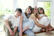 Group shot of boy and girls sitting by the window