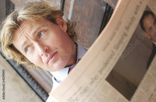 Photo: A man reading a newspaper A man reading a newspaper
