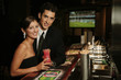 A couple in dinners wear flashing a smile at the camera