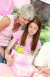A girl and her mother looking at the presents she received