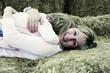 A woman hugging her daughter who is lying on top of her