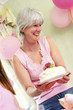 A woman holding a birthday cake