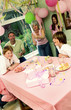 Photo: A man and woman popping out strings of paper in the air to celebrate their daughter's birthday A man and woman popping out strings of paper in the air to celebrate their daughter's birthday