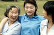Photo: A lady sitting between her mother and grandmother in the park A lady sitting between her mother and grandmother in the park