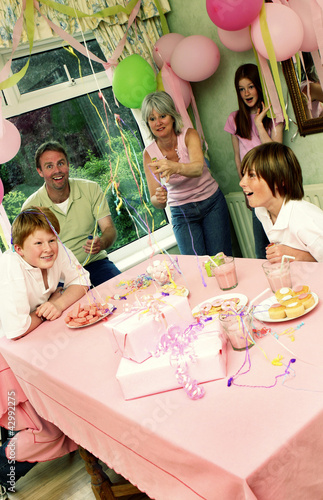 Photo: A man and woman popping out strings of paper in the air to celebrate their daughter's birthday A man and woman popping out strings of paper in the air to celebrate their daughter's birthday