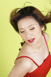 Studio shot of a lady in red dress with her eyes closed