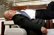 A bald man in business suit sleeping 