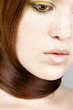 Woman tying her long hair around her neck