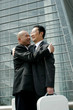 Two businessmen hugging each other 