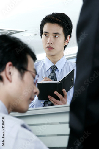 Photo: Man updating his organizer Man updating his organizer