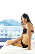 Woman in lacy lingerie sitting on the bed 