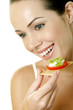 Woman eating biscuit with vegetables