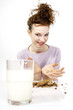 Woman having cookies and a glass of milk for breakfast