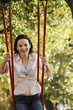 Foto: Woman sitting on a swing Woman sitting on a swing
