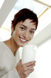 Woman holding a glass of milk