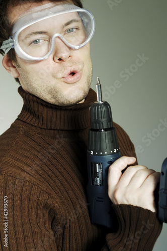 Photo: Man with goggles blowing a drill Man with goggles blowing a drill