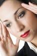 Mascara mixed tears flowing down woman's cheek