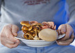 Hands holding a plate of mushrooms 