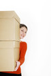 Businesswoman carrying a stack of boxes