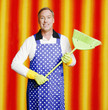 Man in apron holding a broom