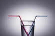 Red and blue drinking straw in a glass of water