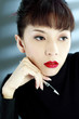 Businesswoman holding a pen, thinking