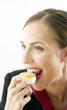 Businesswoman biting into a scone