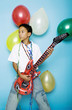 Boy playing with an inflatable guitar