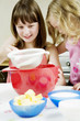 Girls baking cake in the kitchen