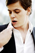 Businessman looking at the lipstick stain on his collar