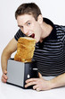 Man trying to eat a stack of toasts