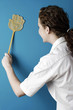 Woman using a fly swatter